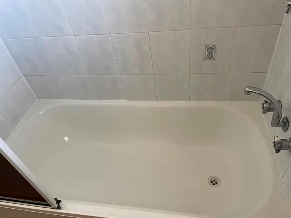Clean white bathtub after a detailed bathroom clean